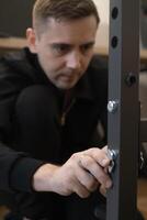 Man assembling furniture in living room showing how easy and convenient it is to create comfort with own hands. photo