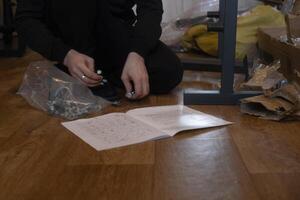 Man assembling home gym equipment creating a comfortable space for workouts and fitness at home. photo