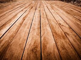 Weathered wooden planks laid parallel on a pathway textured surface with visible grain photo