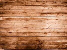 Detailed close up of weathered brown wooden planks with visible grain and knots providing a rustic texture photo