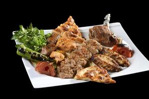 A plate of food with meat, vegetables and bread photo