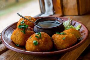 Fried balls with sauce on a plate photo