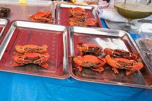 Fresh crab tied with rope ready to be grilled photo