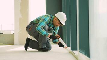 Construction worker applying sealant on window frame video