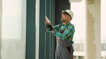 Construction worker applying sealant on window frame video