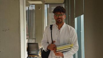 Confident medical student carrying books in university corridor video
