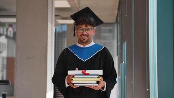 Happy graduated student holding diploma and books smiling at camera video