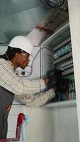 Electrician installing surge protector in electrical panel video