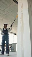 Construction worker applying plaster on a wall with a roller video