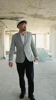 Architect walking through building under construction video