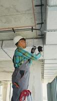 Electrician installing cables on a construction site video