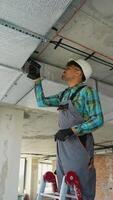 Electrician installing electrical wiring on ceiling video