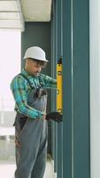 Professional construction worker using spirit level tool for precise measurements indoor video