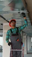 Electrician installing ventilation system on a ladder video