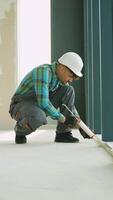 Construction worker applying sealant on floor joint video