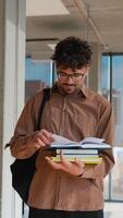 Student reading book in university hallway video