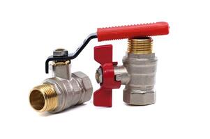 Two ball valves with brass fittings and red and black handles isolated on a white backdrop. photo