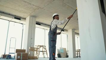 Construction worker using laser distance meter in building video