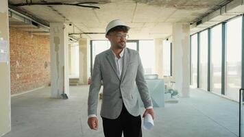 Architect walking through building under construction video