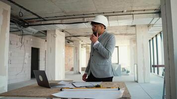 Architect managing construction project while discussing on phone video