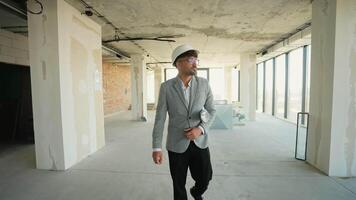 Confident architect walking through unfinished modern interior space video