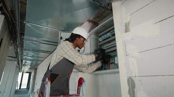 Electrician skillfully installing circuit breakers in industrial setting video