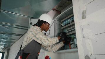 Electrician installing surge protector in electrical panel video