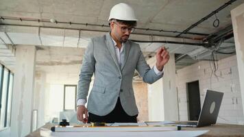 Architect explaining project details during online meeting in building under construction video