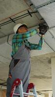 Electrician installing electrical conduit on ceiling video