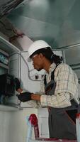 Electrician working on electrical panel installing a new device video