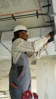 Electrician installing cable on ceiling video