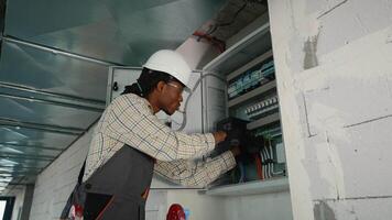 Electrician installing a component in an electrical panel video