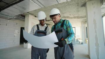 Engineers analyzing blueprint on construction site video