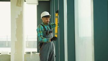 Construction worker using spirit level on window frame video