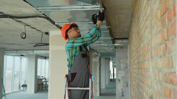 Electrician installing electrical wiring on ceiling video