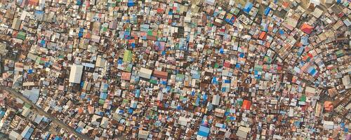 Dense urban area viewed from above, showing colorful rooftops. photo