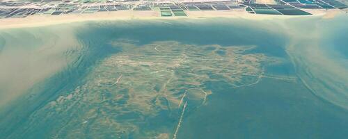 Aerial view of a coastal area with intricate patterns of land and water. photo