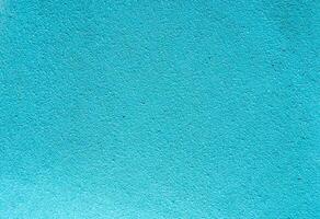 Bright turquoise textured surface, perfect for use as a background in design projects, presentations, templates, posters, or digital graphics with copy space. photo
