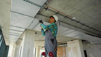 Hvac technician installing air duct in building under construction video