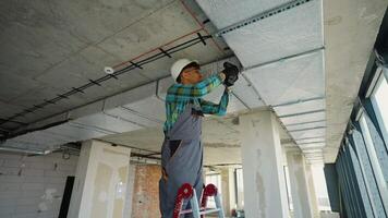 Construction worker installing air conditioning system on a ladder video