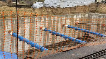 Industrial ballet of blue pipes, rippling reflections, surreal infrastructure nods to International Workers Day, National Engineers Week photo