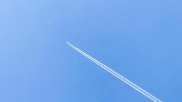 In a boundless azure canvas, a solitary jet leaves trails of whispered dreams, echoing Pilots Day and Sky Awareness Week photo