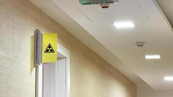 Illuminated corridor with a cryptic radiation sign, evoking Sci fi Day unease, safety protocol ambiance, secretive mystery vibe photo