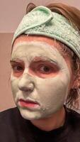 A young Caucasian woman adorned in a lush mint face mask anticipates renewal, like New Moon Celebrations and Hygge rituals photo