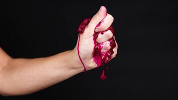 Hand squeezing dragon fruit, juice dripping down video