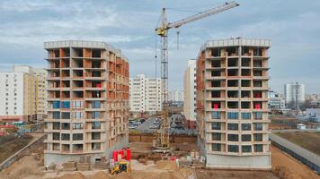 Construction progress of residential buildings with crane and equipment in urban area photo