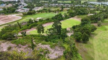 Drone footage captures lush green golf course in Phuket, Thailand, showcasing vibrant landscapes and serene environment under natural daylight video