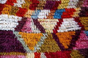 Wool texture of traditional Turkish ethnic patterned carpet closeup photo