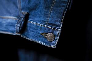 Close-Up of Button and stitching on Blue Jeans, Detailed Denim Design photo