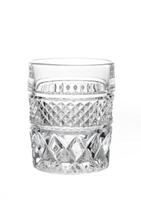 Close-up of an empty cut crystal glass with textured pattern, isolated on white background. photo